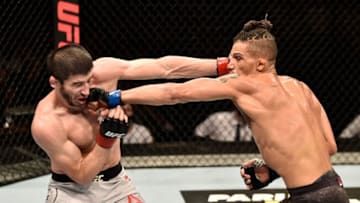 MOSCOW, RUSSIA - SEPTEMBER 15: (R-L) Kajan Johnson of Canada and Rustam Khabilov of Russia exchange punches in their lightweight bout during the UFC Fight Night event at Olimpiysky Arena on September 15, 2018 in Moscow, Russia. (Photo by Jeff Bottari/Zuffa LLC/Zuffa LLC via Getty Images)