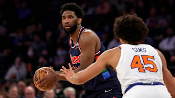 NEW YORK, NEW YORK - FEBRUARY 27: Joel Embiid #21 of the Philadelphia 76ers looks to pass around Jericho Sims #45 of the New York Knicks during the first half at Madison Square Garden on February 27, 2022 in New York City. NOTE TO USER: User expressly acknowledges and agrees that, by downloading and or using this Photograph, user is consenting to the terms and conditions of the Getty Images License Agreement. (Photo by Adam Hunger/Getty Images)