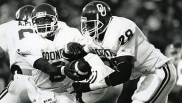 Nov 21, 1987; Lincoln, NE, USA FILE PHOTO; Oklahoma Sooners quarterback Charles Thompson (6) hands off the ball to fullback Rotnei Anderson (28) in action against the Nebraska Cornhuskers. Oklahoma beat Nebraska 17-7. Mandatory Credit: Malcolm Emmons-USA TODAY Sports