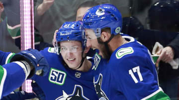 VANCOUVER, BC - NOVEMBER 14: Troy Stecher #51 of the Vancouver Canucks is congratulated by teammate Josh Leivo #17 after scoring during their NHL game against the Dallas Stars at Rogers Arena November 14, 2019 in Vancouver, British Columbia, Canada. (Photo by Jeff Vinnick/NHLI via Getty Images)