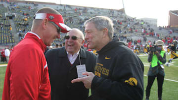 IOWA CITY, IOWA - NOVEMBER 2: Head coach Kirk Ferentz, right, of the Iowa Hawkeyes talks with athletic director Barry Alvarez, center, and head coach Gary Andersen of the Wisconsin Badgers, before their match-up on November 2, 2013 at Kinnick Stadium in Iowa City, Iowa. (Photo by Matthew Holst/Getty Images)