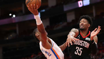 Shai Gilgeous-Alexander #2 of the Oklahoma City Thunder drives against Christian Wood #35 of the Houston Rockets during the second half at Toyota Center on November 29, 2021 in Houston, Texas. NOTE TO USER: User expressly acknowledges and agrees that, by downloading and or using this photograph, User is consenting to the terms and conditions of the Getty Images License Agreement. (Photo by Carmen Mandato/Getty Images)