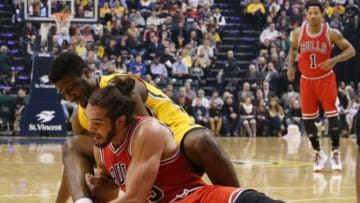 Dec 29, 2014; Indianapolis, IN, USA; Chicago Bulls center Joakim Noah (13) battles for a loose ball with Indiana Pacers forward Solomon Hill (44) at Bankers Life Fieldhouse. Mandatory Credit: Brian Spurlock-USA TODAY Sports