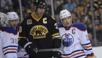 Feb 1, 2014; Boston, MA, USA; Boston Bruins defenseman Zdeno Chara (33) and Edmonton Oilers defenseman Andrew Ference (21) during the first period at TD Banknorth Garden. Mandatory Credit: Bob DeChiara-USA TODAY Sports
