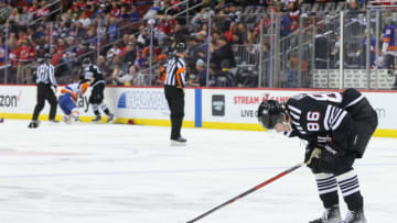 New Jersey Devils center Jack Hughes (86) leaves the ice after being hit by New York Islanders right wing Oliver Wahlstrom (not shown) during the second period at Prudential Center. Mandatory Credit: Ed Mulholland-USA TODAY Sports