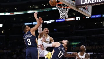 Russell Westbrook #0 of the Los Angeles Lakers reacts as he attempts to layup against CJ McCollum #3 of the New Orleans Pelicans and Jonas Valanciunas #17 of the New Orleans Pelicans (Photo by Michael Owens/Getty Images)