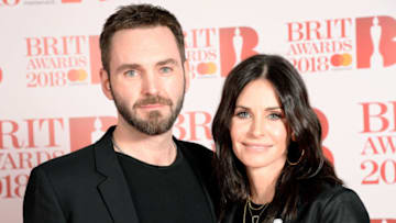 LONDON, ENGLAND - FEBRUARY 21: *** EDITORIAL USE ONLY IN RELATION TO THE BRIT AWARDS 2018 *** Johnny McDaid (L) and Courteney Cox attend The BRIT Awards 2018 held at The O2 Arena on February 21, 2018 in London, England. (Photo by Dave J Hogan/Dave J Hogan/Getty Images)