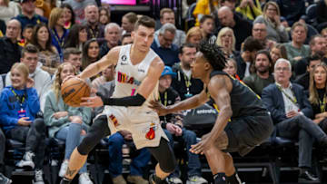Dec 31, 2022; Salt Lake City, Utah, USA; Miami Heat guard Tyler Herro (14) dribbles the ball against Utah Jazz guard Collin Sexton (2) during the first quarter at Vivint Arena. Mandatory Credit: Christopher Creveling-USA TODAY Sports