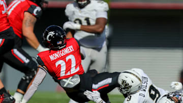 UCF Knights defensive back Divaad Wilson brings down Cincinnati Bearcats running back Ryan Montgomery. USA Today.