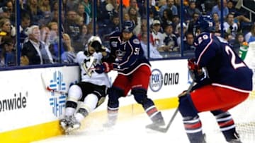 Sep 23, 2014; Columbus, OH, USA; Pittsburg Penguins center Dominik Uher (46) falls to the ice after a check from Columbus Blue Jackets defenseman Fedor Tyutin (51) during the third period at Nationwide Arena. Columbus defeated Pittsburg 2-0. Mandatory Credit: Russell LaBounty-USA TODAY Sports