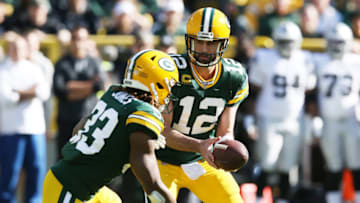 GREEN BAY, WISCONSIN - OCTOBER 20: Aaron Rodgers #12 of the Green Bay Packers hands off to Aaron Jones #33 during the first half against the Oakland Raiders in the game at Lambeau Field on October 20, 2019 in Green Bay, Wisconsin. (Photo by Dylan Buell/Getty Images)