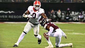 Nov 12, 2022; Starkville, Mississippi, USA; Georgia Bulldogs tight end Darnell Washington (0) runs the ball against Mississippi State Bulldogs cornerback Decamerion Richardson (3) during the third quarter at Davis Wade Stadium at Scott Field. Mandatory Credit: Matt Bush-USA TODAY Sports