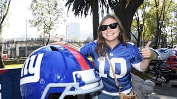Nov 21, 2016; Mexico City, MEX; Female fan poses with replica New York Giants helmet during the NFL Fan Fest at Chapultepec Park prior to the NFL International Series game between the Houston Texans and the Oakland Raiders. Mandatory Credit: Kirby Lee-USA TODAY Sports