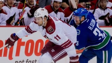 Sep 29, 2014; Vancouver, British Columbia, CAN; Vancouver Canucks forward Henrik Sedin (33) attempts to check Arizona Coyotes forward Martin Hanzal (11) during the third period at Rogers Arena. Arizona won 4-2. Mandatory Credit: Bob Frid-USA TODAY Sports