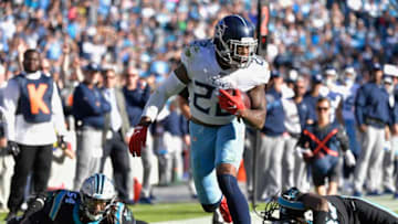 CHARLOTTE, NORTH CAROLINA - NOVEMBER 03: Derrick Henry #22 of the Tennessee Titans breaks away from Shaq Thompson #54and Tre Boston #33 of the Carolina Panthers for a touchdown during the fourth quarter of their game at Bank of America Stadium on November 03, 2019 in Charlotte, North Carolina. (Photo by Grant Halverson/Getty Images)