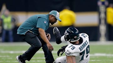 NEW ORLEANS, LOUISIANA - JANUARY 13: Brandon Brooks #79 of the Philadelphia Eagles is tended to by the trainer after sustaining a second quarter injury against the New Orleans Saints in the NFC Divisional Playoff Game at Mercedes Benz Superdome on January 13, 2019 in New Orleans, Louisiana. (Photo by Jonathan Bachman/Getty Images)