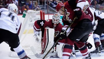Oct 29, 2016; Glendale, AZ, USA; Arizona Coyotes goalie Louis Domingue (35) defends Colorado Avalanche defenseman Tyson Barrie (4) during the third period at Gila River Arena. Mandatory Credit: Matt Kartozian-USA TODAY Sports