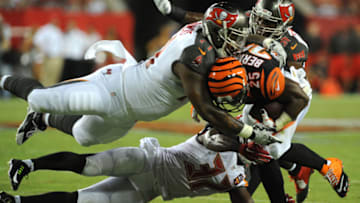 TAMPA, FL - AUGUST 24: Defensive end #71 Da'Quan Bowers tackles running back Giovani Bernard #25 of the Cincinnati Bengals in the second quarter at Raymond James Stadium on August 24, 2015 in Tampa, Florida. (Photo by Cliff McBride/Getty Images)