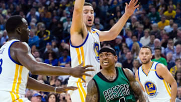 Mar 8, 2017; Oakland, CA, USA; Boston Celtics guard Isaiah Thomas (4) controls the ball between Golden State Warriors forward Draymond Green (23), guard Klay Thompson (11) and guard Stephen Curry (30) during the third quarter at Oracle Arena. The Boston Celtics defeated the Golden State Warriors 99-86. Mandatory Credit: Kelley L Cox-USA TODAY Sports