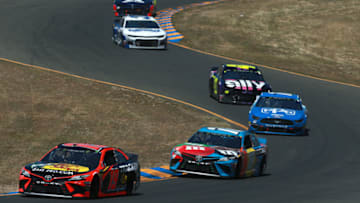 SONOMA, CALIFORNIA - JUNE 23: Martin Truex Jr., driver of the #19 Bass Pro Shops Toyota, leads a pack of cars during the Monster Energy NASCAR Cup Series Toyota/Save Mart 350 at Sonoma Raceway on June 23, 2019 in Sonoma, California. (Photo by Sean Gardner/Getty Images)