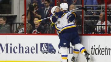 Feb 28, 2016; Raleigh, NC, USA; St. Louis Blues forward Kyle Brodziak (28) celebrates his second period short handed goal with teammate forward Scottie Upshall (10) against the Carolina Hurricanes at PNC Arena. Mandatory Credit: James Guillory-USA TODAY Sports