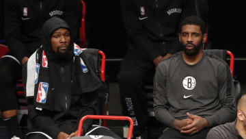 NEW YORK, NEW YORK - DECEMBER 22: (NEW YORK DAILIES OUT) Kevin Durant #7 (L) and Kyrie Irving #11 of the Brooklyn Nets look on against the Golden State Warriors at Barclays Center on December 22, 2020 in New York City. The Nets defeated the Warriors 125-99. NOTE TO USER: User expressly acknowledges and agrees that, by downloading and/or using this photograph, user is consenting to the terms and conditions of the Getty Images License Agreement. (Photo by Jim McIsaac/Getty Images)