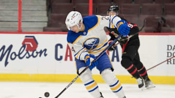 Jan 25, 2022; Ottawa, Ontario, CAN; Buffalo Sabres center Dylan Cozens (24) settles the puck in the first period against the Ottawa Senators at the Canadian Tire Centre. Mandatory Credit: Marc DesRosiers-USA TODAY Sports