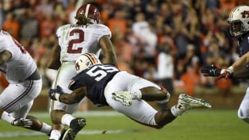 Nov 28, 2015; Auburn, AL, USA; Alabama Crimson Tide running back Derrick Henry (2) runs the ball as Auburn Tigers defensive lineman Carl Lawson (55) tackles during the third quarter at Jordan Hare Stadium. Mandatory Credit: Shanna Lockwood-USA TODAY Sports