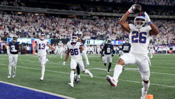 EAST RUTHERFORD, NEW JERSEY - SEPTEMBER 26: Saquon Barkley #26 of the New York Giants scores a 36 yard touchdown against the Dallas Cowboys during the third quarter in the game at MetLife Stadium on September 26, 2022 in East Rutherford, New Jersey. (Photo by Elsa/Getty Images)