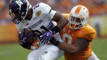 Jan 1, 2016; Tampa, FL, USA; Northwestern Wildcats running back Justin Jackson (21) runs the ball against Tennessee Volunteers defensive back Derek Barnett (9) in the second half at the 2016 Outback Bowl at Raymond James Stadium. Tennessee defeated Northwestern 45-6. Mandatory Credit: Mark Zerof-USA TODAY Sports