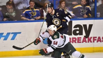 Feb 6, 2016; St. Louis, MO, USA; St. Louis Blues center David Backes (42) checks Minnesota Wild left wing Erik Haula (56) during the third period at Scottrade Center. The St. Louis Blues defeat the Minnesota Wild 4-1. Mandatory Credit: Jasen Vinlove-USA TODAY Sports