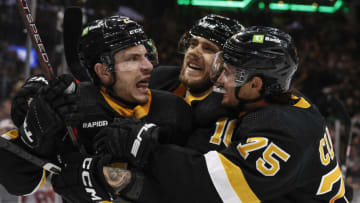 Mar 11, 2023; Boston, Massachusetts, USA; Boston Bruins right wing Garnet Hathaway (21) (left) is congratulated by defenseman Connor Clifton (75) and left wing A.J. Greer (10) after scoring the go ahead goal against the Detroit Red Wings during the third period at TD Garden. Mandatory Credit: Winslow Townson-USA TODAY Sports