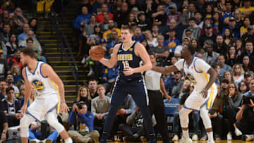 OAKLAND, CA - JANUARY 8: Nikola Jokic #15 of the Denver Nuggets handles the ball against the Golden State Warriors on January 8, 2018 at ORACLE Arena in Oakland, California. NOTE TO USER: User expressly acknowledges and agrees that, by downloading and or using this photograph, user is consenting to the terms and conditions of Getty Images License Agreement. Mandatory Copyright Notice: Copyright 2018 NBAE (Photo by Noah Graham/NBAE via Getty Images)