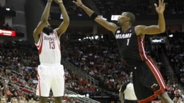 Nov 12, 2012; Houston, TX, USA; Houston Rockets shooting guard James Harden (13) takes a shot over Miami Heat center Chris Bosh (1) in the fourth quarter at the Toyota Center. The Heat defeated the Rockets 113-110. Mandatory Credit: Brett Davis-USA TODAY Sports