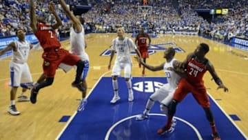 Dec 28, 2013; Lexington, KY, USA; Louisville Cardinals guard Russ Smith (2) shoots against Kentucky Wildcats guard Aaron Harrison (2) during the second half at Rupp Arena. Kentucky defeated Louisville 73-66. Mandatory Credit: Jamie Rhodes-USA TODAY Sports