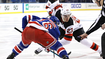 Mikhail Maltsev #23 of the New Jersey Devils and Ryan Strome #16 of the New York Rangers face off. Credit: Elsa/POOL PHOTOS-USA TODAY Sports