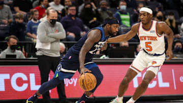 MINNEAPOLIS, MN - DECEMBER 28: Patrick Beverley #22 of the Minnesota Timberwolves dribbles the ball whiel Immanuel Quickley #5 of the New York Knicks defends in the second quarter of the game at Target Center on December 28, 2021 in Minneapolis, Minnesota. The Knicks defeated the Timberwolves 96-88. NOTE TO USER: User expressly acknowledges and agrees that, by downloading and or using this Photograph, user is consenting to the terms and conditions of the Getty Images License Agreement. (Photo by David Berding/Getty Images)