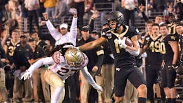 WINSTON SALEM, NORTH CAROLINA - OCTOBER 19: Sage Surratt #14 of the Wake Forest Demon Deacons makes a catch against Akeem Dent #27 of the Florida State Seminoles during the first half of their game at BB&T Field on October 19, 2019 in Winston Salem, North Carolina. (Photo by Grant Halverson/Getty Images)