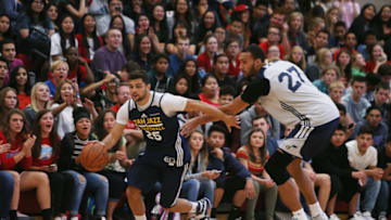 SALT LAKE CITY, UT - SEPTEMBER 30: Raul Neto #25 of the Utah Jazz drives against Rudy Gobert #27 during a surprise scrimmage at Granger High School on September 30, 2016 in Salt Lake City, Utah. Copyright 2016 NBAE (Photo by Melissa Majchrzak/NBAE via Getty Images)