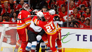 CALGARY, AB - APRIL 13: Garnet Hathaway #21 of the Calgary Flames is pushed by Matt Calvert #11 of the Colorado Avalanche in Game Two of the Western Conference First Round during the 2019 NHL Stanley Cup Playoffs on April 13, 2019 at the Scotiabank Saddledome in Calgary, Alberta, Canada. (Photo by Gerry Thomas/NHLI via Getty Images)