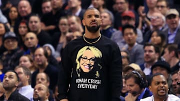 TORONTO, ON - NOVEMBER 16: Drake looks on from his courtside seat during the second half of an NBA game between the Golden State Warriors and the Toronto Raptors at Air Canada Centre on November 16, 2016 in Toronto, Canada. NOTE TO USER: User expressly acknowledges and agrees that, by downloading and or using this photograph, User is consenting to the terms and conditions of the Getty Images License Agreement. (Photo by Vaughn Ridley/Getty Images)
