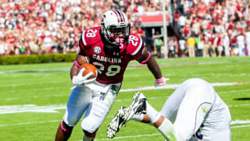 South Carolina football's Mike Davis with a vicious stiff arm against Furman. Mandatory Credit: Jeff Blake-USA TODAY Sports