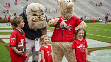 Apr 16, 2022; Athens, Georgia, USA; Georgia Bulldogs mascot Hairy Dawg and Atlanta Braves mascot Blooper pose with fans prior to the start of the Georgia Bulldogs Spring Game at Sanford Stadium. Mandatory Credit: Dale Zanine-USA TODAY Sports