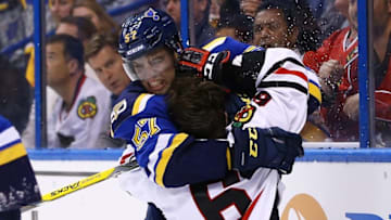 Nov 9, 2016; St. Louis, MO, USA; St. Louis Blues left wing David Perron (57) and Chicago Blackhawks defenseman Michal Kempny (6) tangle after a hard check into the boards during the second period at Scottrade Center. Mandatory Credit: Billy Hurst-USA TODAY Sports