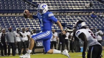 Sep 26, 2020; Provo, UT, USA; BYU quarterback Zach Wilson (1) leaps as he scores against Troy linebacker Carlton Martial (2) in the second half during an NCAA college football game Saturday, Sept. 26, 2020, in Provo, Utah. Mandatory Credit: Rick Bowmer/Pool Photo-USA TODAY Sports