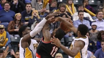 Dec 13, 2014; Indianapolis, IN, USA; Portland Trail Blazers forward LaMarcus Aldridge (12) is defended on a shot by Indiana Pacers center Roy Hibbert (55) and forward Solomon Hill (44) at Bankers Life Fieldhouse. Portland defeats Indiana 95-85. Mandatory Credit: Brian Spurlock-USA TODAY Sports