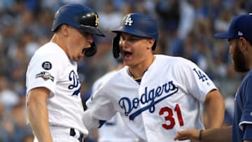 LOS ANGELES, CALIFORNIA - OCTOBER 09: Kike Hernandez #14 of the Los Angeles Dodgers celebrates his solo home run with teammate Joc Pederson #31 to take a 3-0 lead in the second inning of game five of the National League Division Series against the Washington Nationals at Dodger Stadium on October 09, 2019 in Los Angeles, California. (Photo by Harry How/Getty Images)