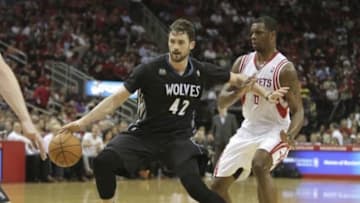 Mar 20, 2014; Houston, TX, USA; Minnesota Timberwolves forward Kevin Love (42) drives to the basket against Houston Rockets forward Terrence Jones (6) during the third quarter at Toyota Center. Mandatory Credit: Andrew Richardson-USA TODAY Sports