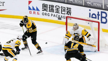 Jan 28, 2021; Boston, Massachusetts, USA; Boston Bruins center Sean Kuraly (52) scores a goal against Pittsburgh Penguins goalie Tristan Jarry (35) during the first period at TD Garden. Mandatory Credit: Paul Rutherford-USA TODAY Sports