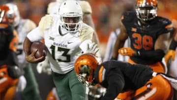 Nov 21, 2015; Stillwater, OK, USA; Baylor Bears quarterback Chris Johnson (13) attempts to avoid the tackle of Oklahoma State Cowboys cornerback Ashton Lampkin (6) in the fourth quarter at Boone Pickens Stadium. Baylor won 45-35. Mandatory Credit: Tim Heitman-USA TODAY Sports
